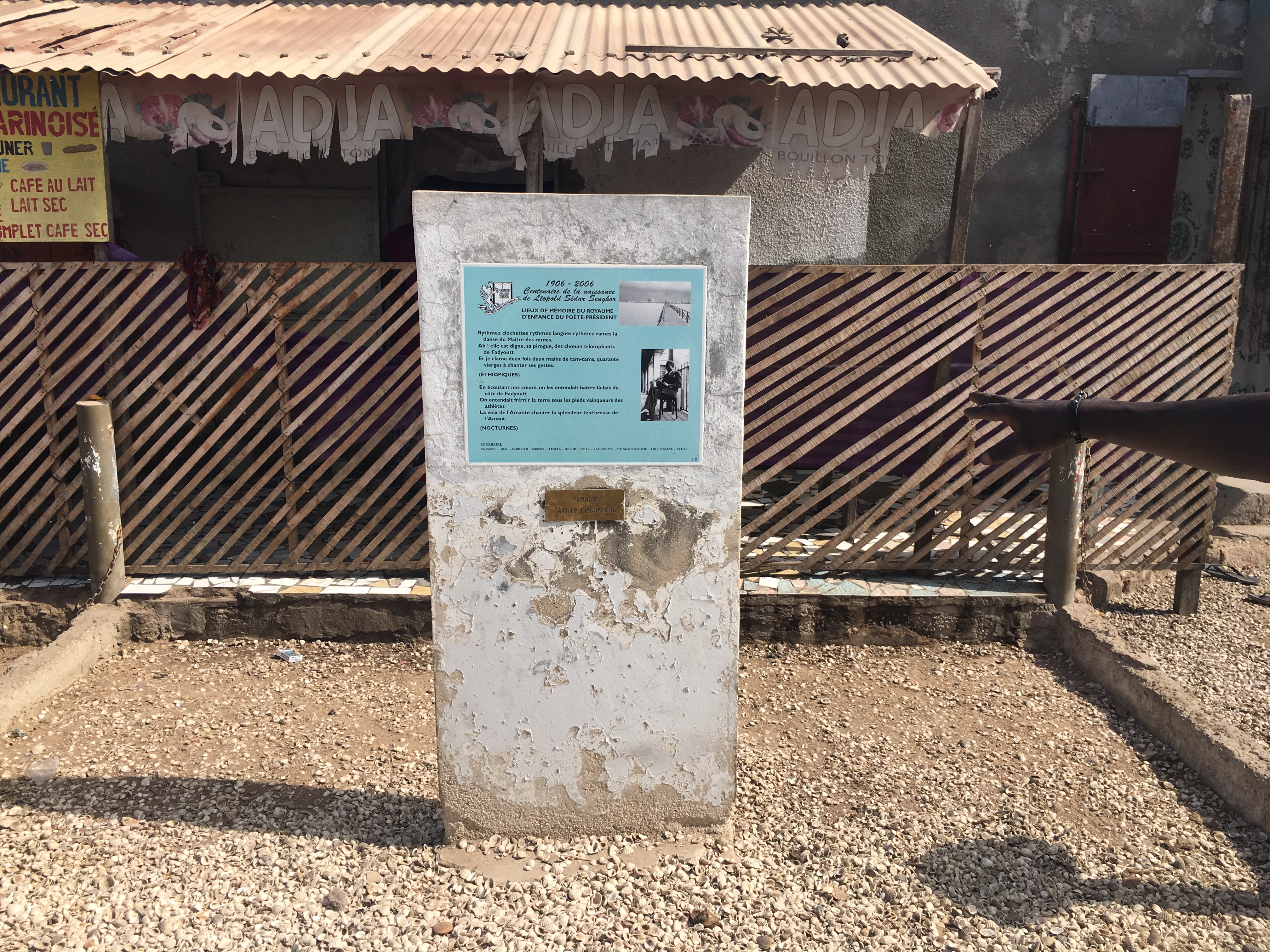 back view of woman wearing a backpack and beanie waiting to cross the road on a busy street at night in New York City, USA